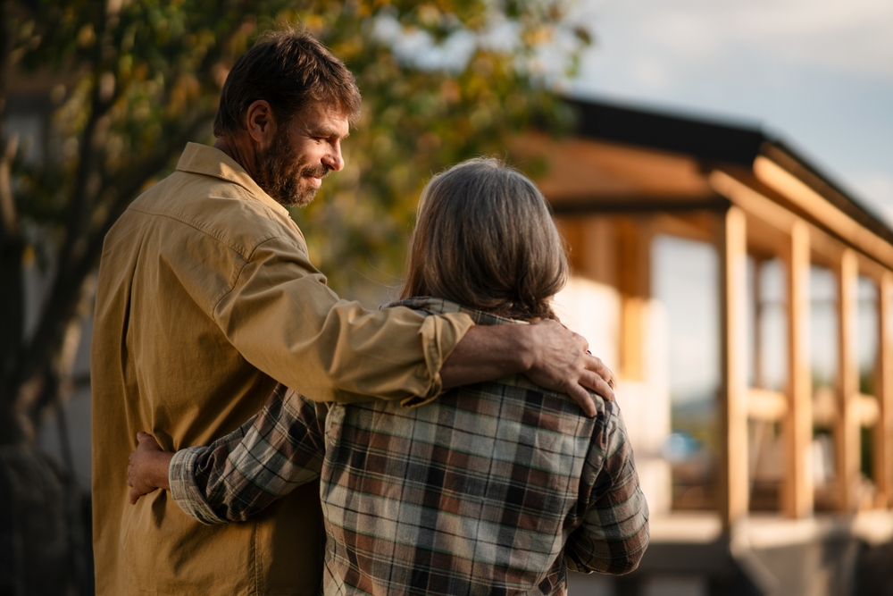 Image of a mature couple looking at their new house currently being built.